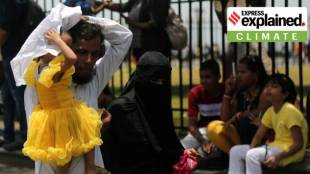 A family tries shielding from the sun in Mumbai, Maharashtra. (Express Photo By Ganesh Shirsekar, File)